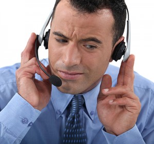 Businessman struggling to hear his headset